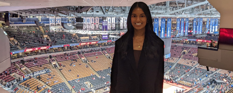 A photo of Riana standing at the Toronto Raptors basketball arena.