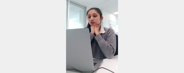 University of Waterloo Master's student, Yayaakshi Shokeen, looking at a laptop