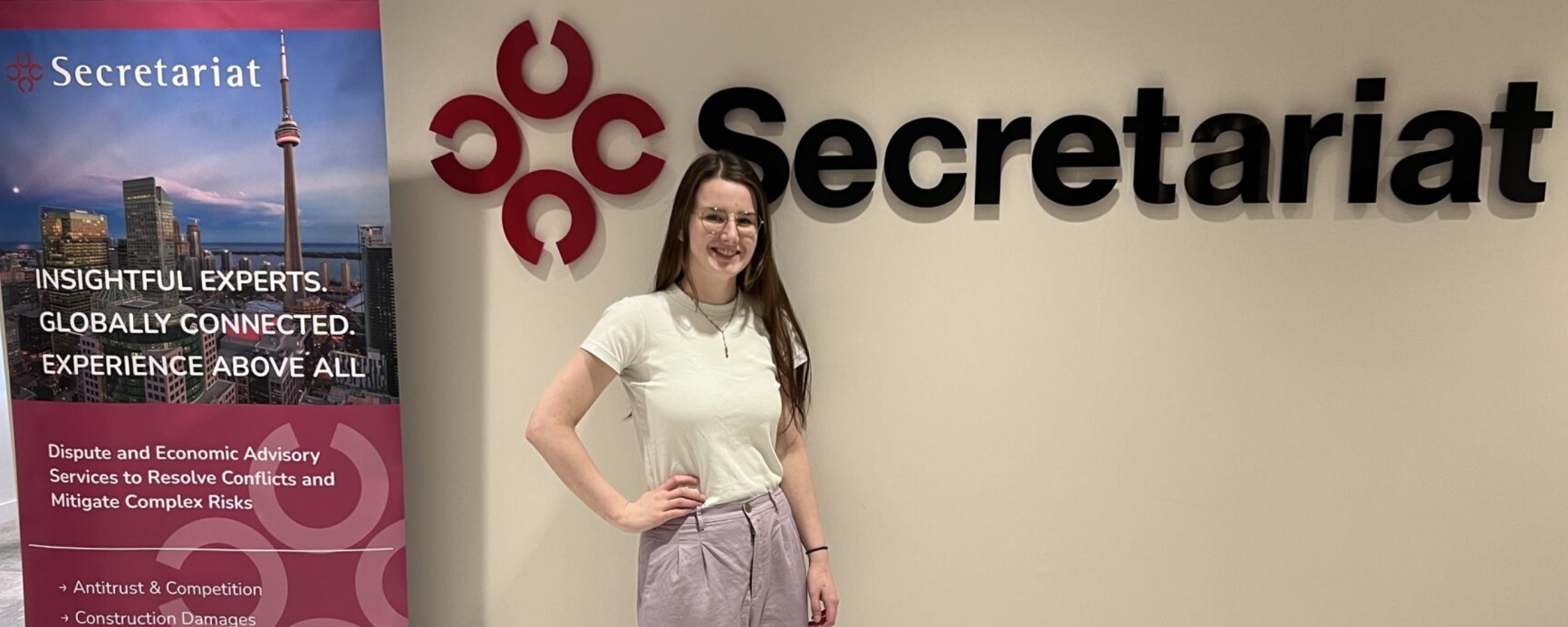 Hannah Teetzel standing in front of Secretariat logo