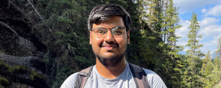 University of Waterloo student, Shashwat Murawala, smiling in the forest.
