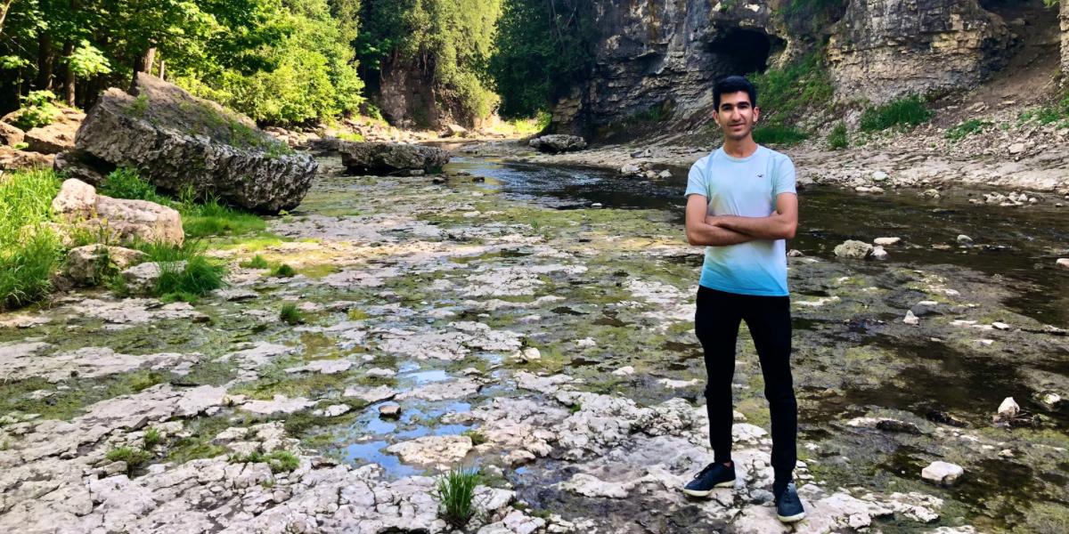 University of Waterloo Environment Co-op student, Ayman smiling outdoors