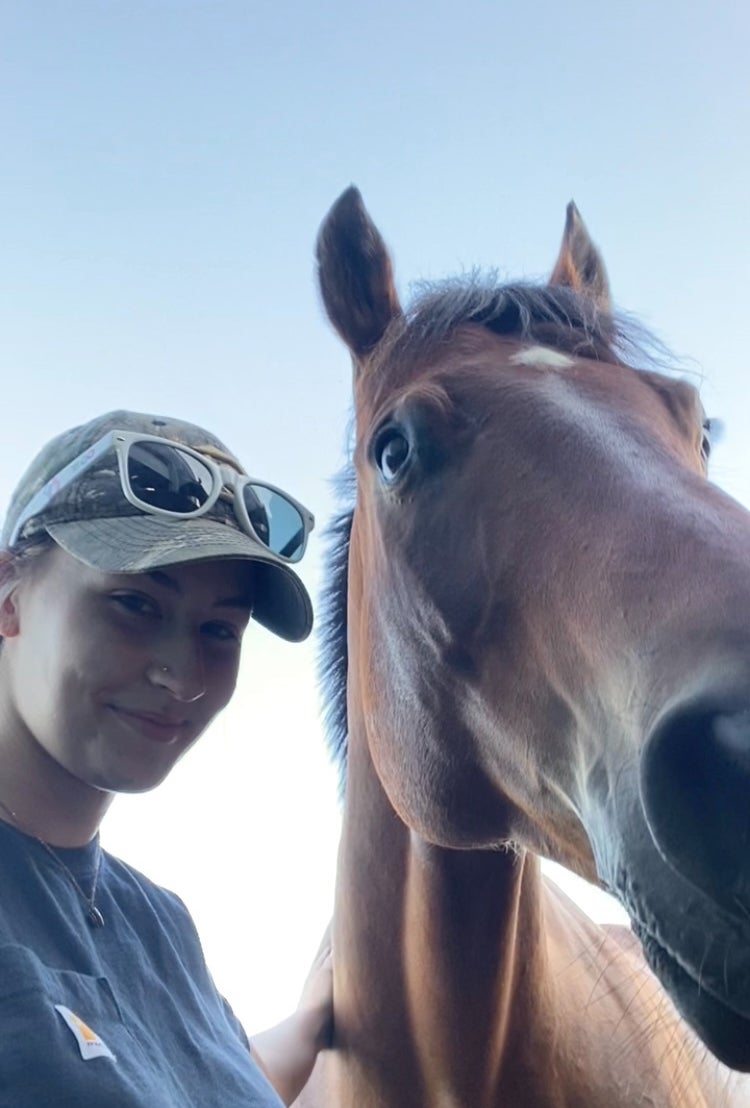 Lexi posing with a horse