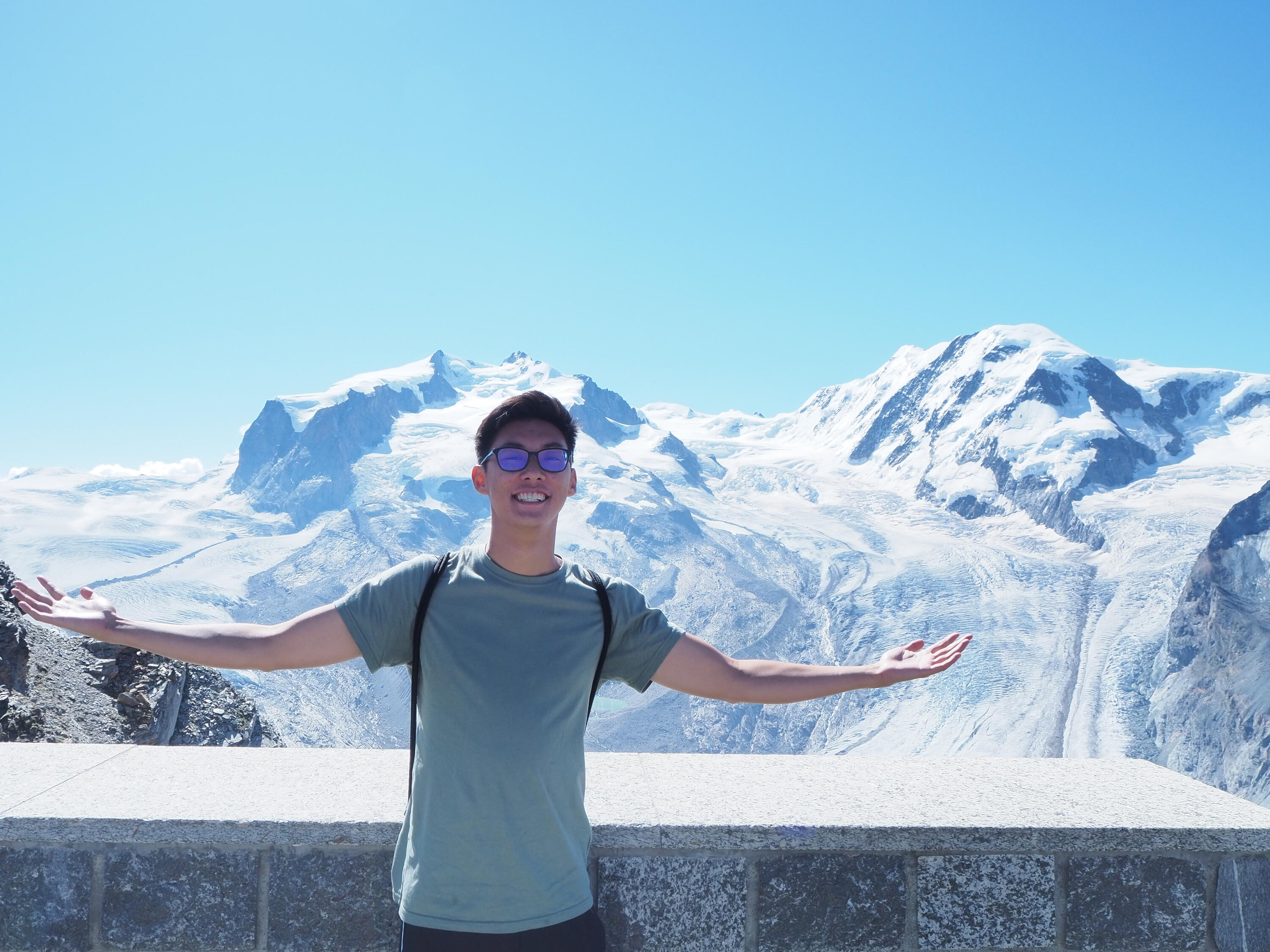 picture of andrew in front of a mountain range 