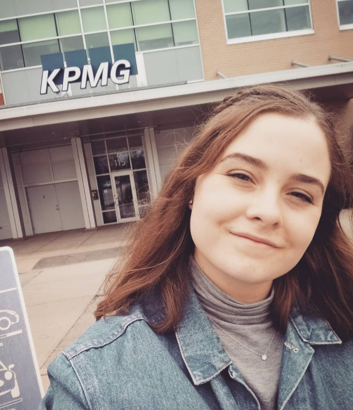 Photo of Daynica smiling in front of KPMG building 