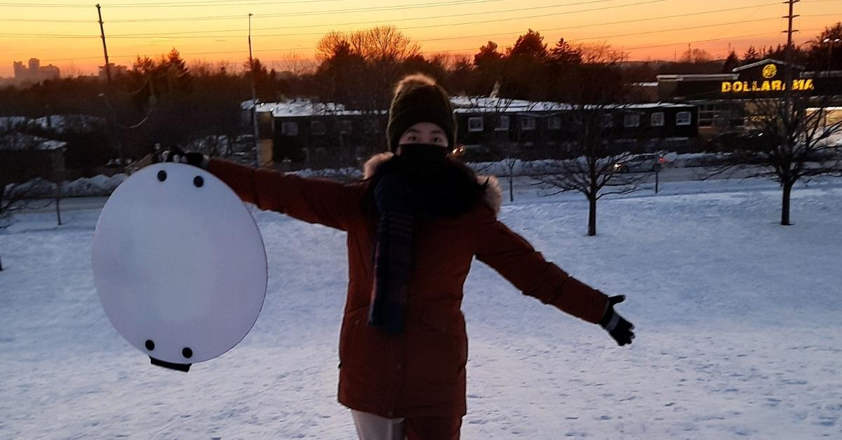 Cecilia Qiu standed in the snow during sunset