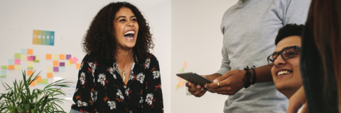 Female co-op student smiling while talking to peers in the office