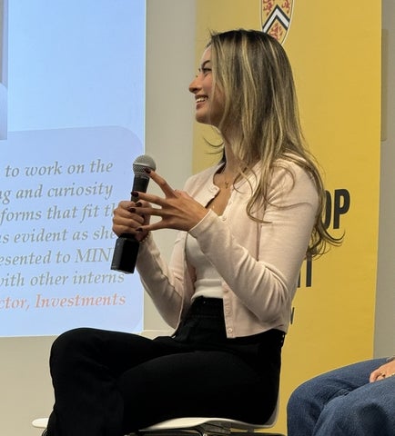 Breanna Levy sitting on a chair with a microphone