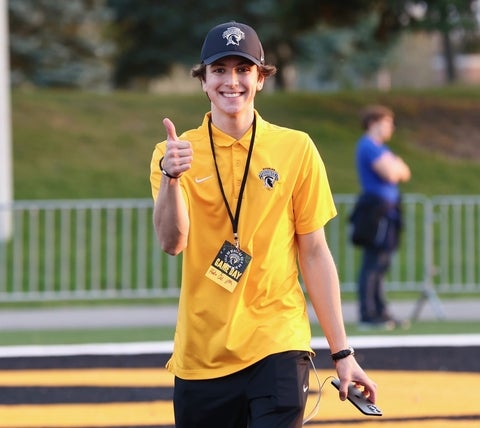 Cameron Stirrup in game day uniform, smiling with thumbs up