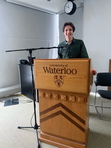 Cameron Stirrup standing at a University of Waterloo podium