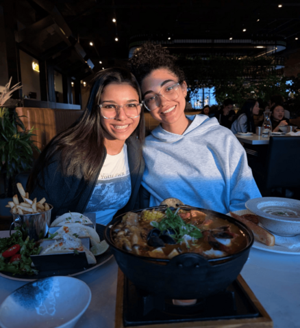 Carole Hanna smiling with a friend at a restaurant