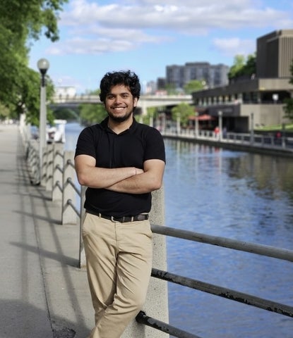 Vinayak Bector posing in front of Rideau Canal