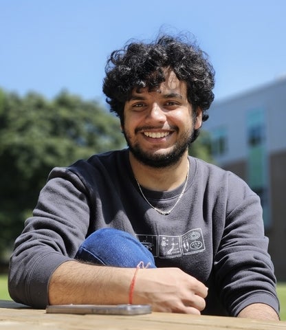 Vinayak Bector sitting on a University of Waterloo bench