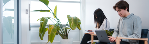 Two co-op students sitting on their laptops