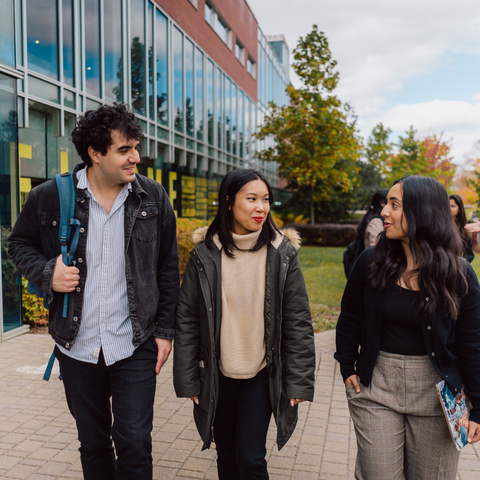 three student walking together outside of the Tathum Centre 