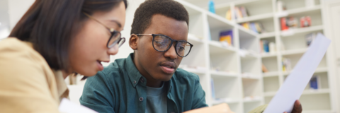 two students looking at a piece of paper