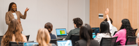An employer leading a session and a co-op student is raising their hand
