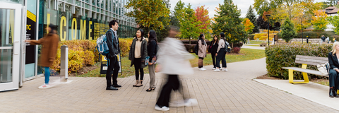 students walking and talking outside the tatham centre 