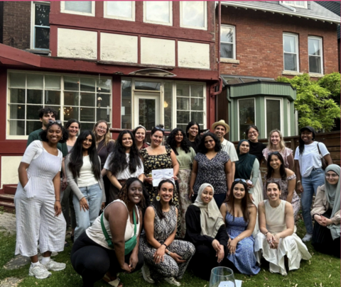 Aiden Sarrafzadeh posing with a large group of people