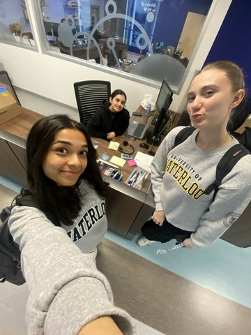 disha patel smiling with friends in the Science Undergraduate Office