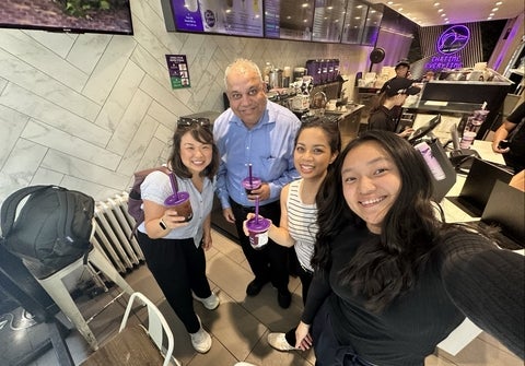 Emily Fitzgerald and three co-workers posing with bubble tea cups at Chatime
