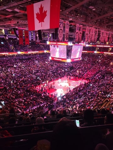 A packed indoor arena during a basketball game