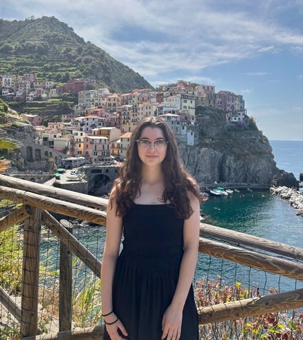 Francesca Girmenia posing in front of Manarola in Cinque Terre, Italy 