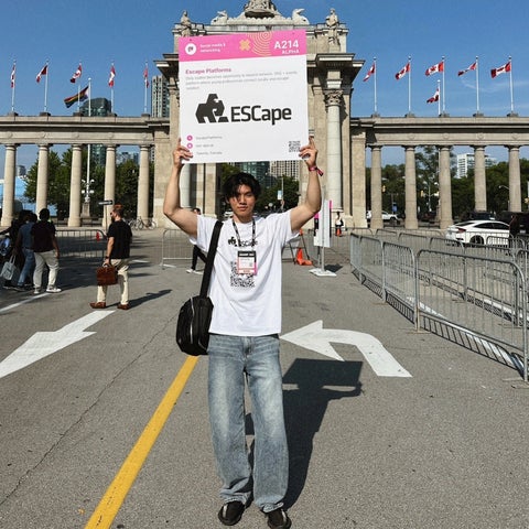 Hyeseong posing with a sign that says "ESCape"