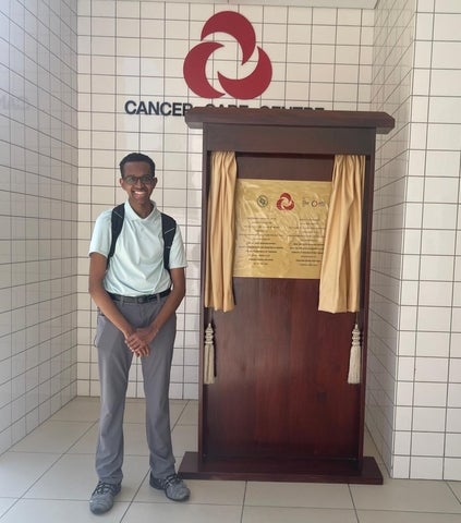 Zeeyaan Bourdeau, Health Sciences co-op student, posing in front of the Cancer Care Centre