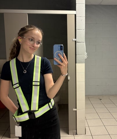 Catherine Mulcaster taking a mirror selfie wearing high-visibility vest
