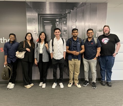 Jane Zeng posing with six collegues 