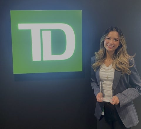 Breanna Levy standing next to the TD logo