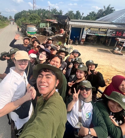Co-op students next to a road in Indonesia posing for a group selfie