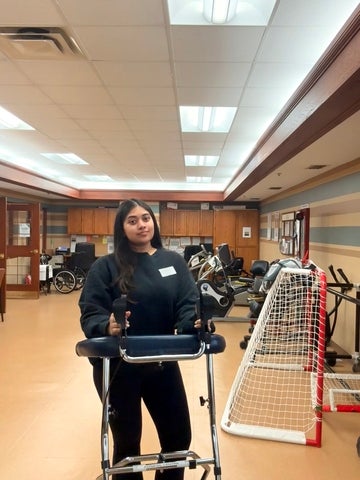 Jashmira Premkumar standing in a rehabilitation and mobility exercise space during a co-op placement at Schlegel Villages.