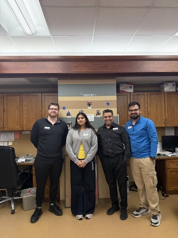 Jashmira Premkumar posing at work with her colleagues