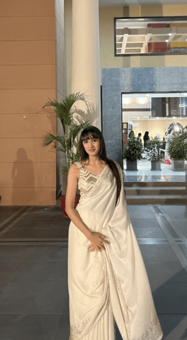 Ketna Khattar posing in a long white dress 