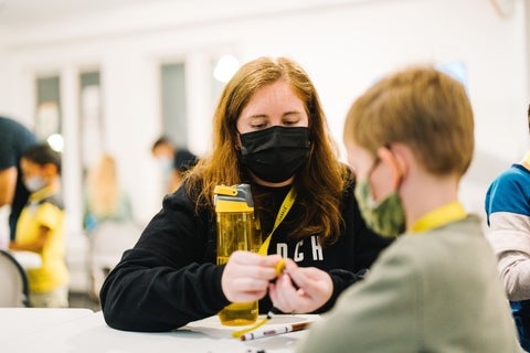 Amanda helping a young student out while working at LAUNCH Waterloo
