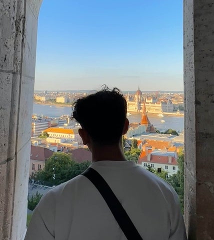 Lokesh posing in a window in Budapest