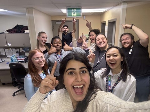 Mariam and co-workers smiling and posing