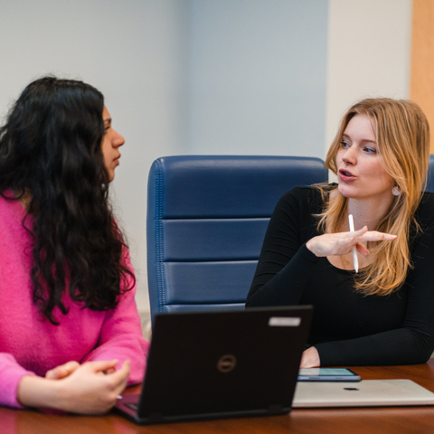  Two students talking to each other 