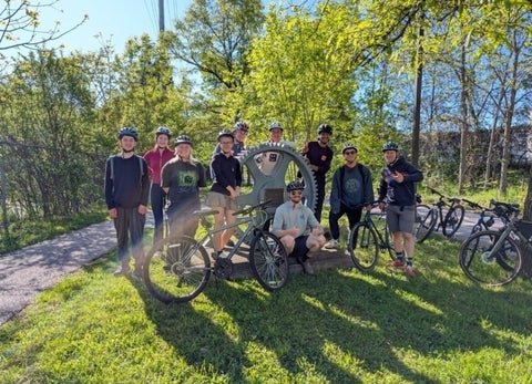 Octavia Andrushko posing with classmates on a bike ride