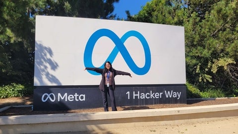 Padena Rasouli-Baghban posing in front of a Meta sign