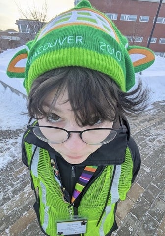 Phoenix Rogoz outside in a high visibility vest and hat