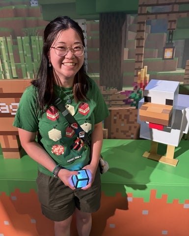 Miriam Tam smiling in front of Minecraft related scene