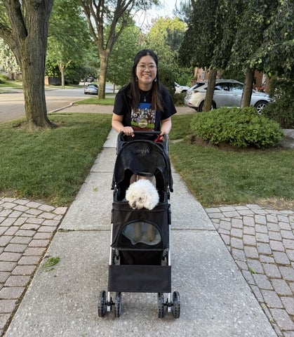 Miriam Tam pushing a stroller with a dog in it