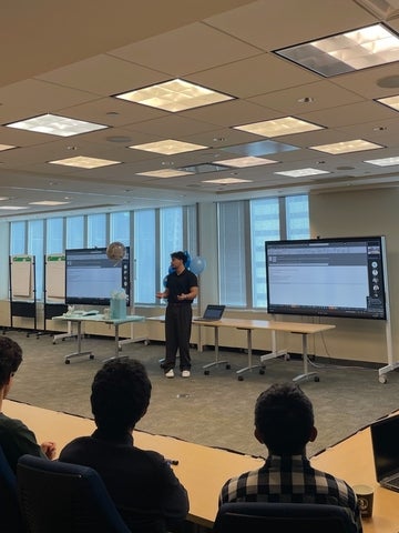 Rafin Khan presenting in front of an audience