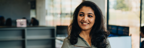 Student smiling about rank and match holding her laptop