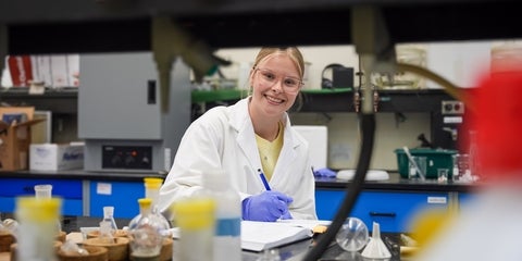 Allysa Greidanus smiling in a science lab