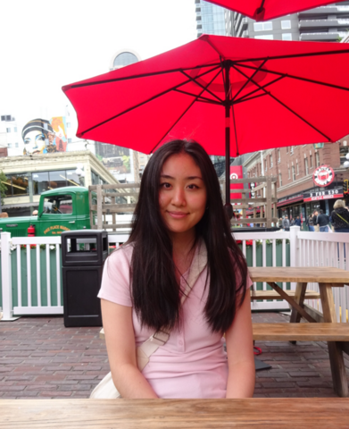 Christina Yang sitting at a table