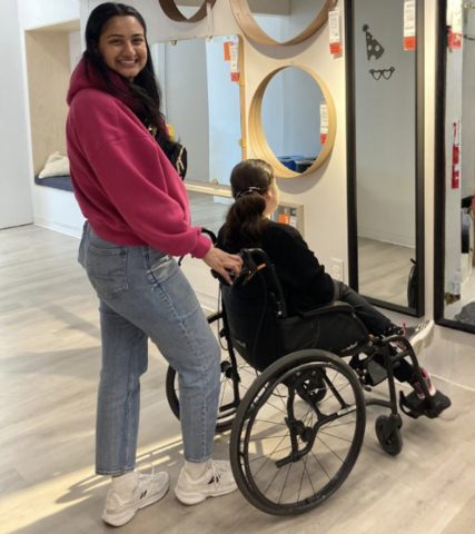 Kelly Ramnarais posing while pushing a person in a wheelchair