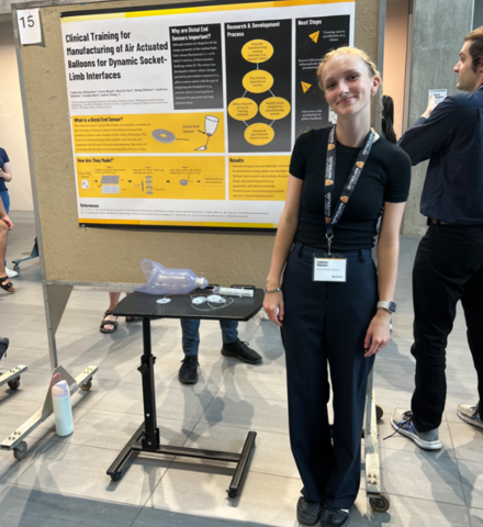 Catherine Mulcaster posing in front a presentation board